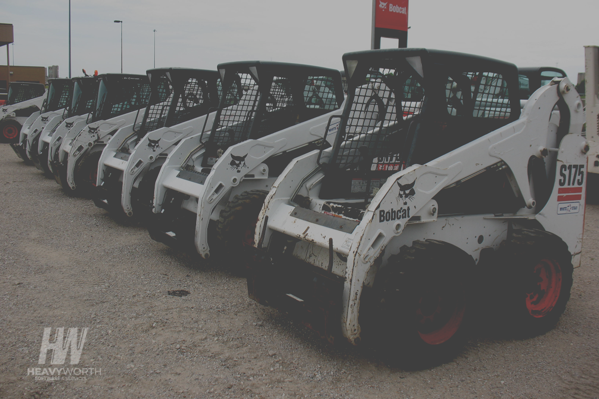 skid steers lined up at an equipment dealership